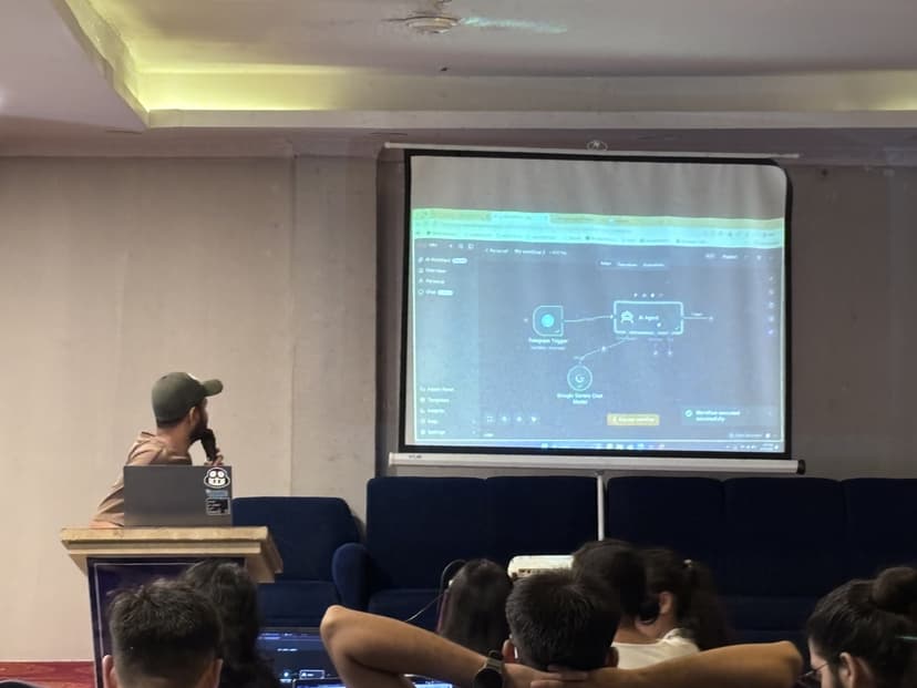Tushar Rayamajhi explaining an AI agent workflow on the projector screen